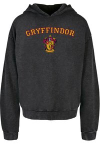Felpa con cappuccio nera con testo "Gryffindor" in rosso, e logo a ricamo colorato sul davanti; realizzata in tessuto morbido con una vestibilità comoda.