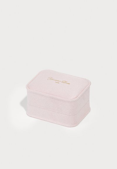 Cutie de bijuterii roz, realizată dintr-un material texturat, cu o formă rectangulară. Prezintă un logo auriu pe capac și margini moi. Design compact.