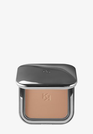 Compact powder makeup in rectangular silver case with embossed logo on lid and powder surface, beige shade.