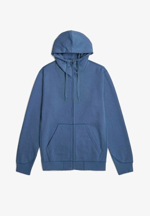 Blauwe zip-up hoodie met een trekkoordcapuchon, voorzakken en geribbelde manchetten. Gemaakt van zacht materiaal met een gladde textuur.