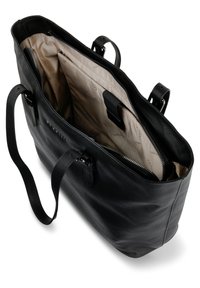 Sac fourre-tout en cuir noir avec une forme structurée, fermeture éclair, deux poignées et un intérieur doublé de beige comportant des poches pour l'organisation.