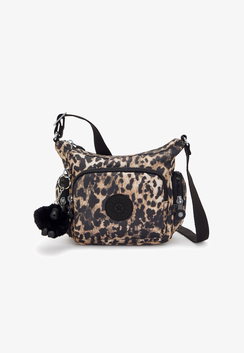 Dyreprint crossbody taske i beige og sort stof med justerbar rem, lynlåslommer og en pelsagtig nøglering som detalje.