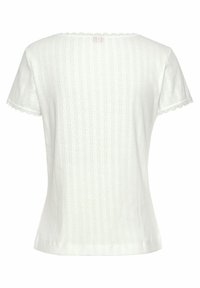 White short-sleeve shirt with a scalloped neckline, featuring vertical stripes and delicate diamond patterns. Soft, textured fabric.