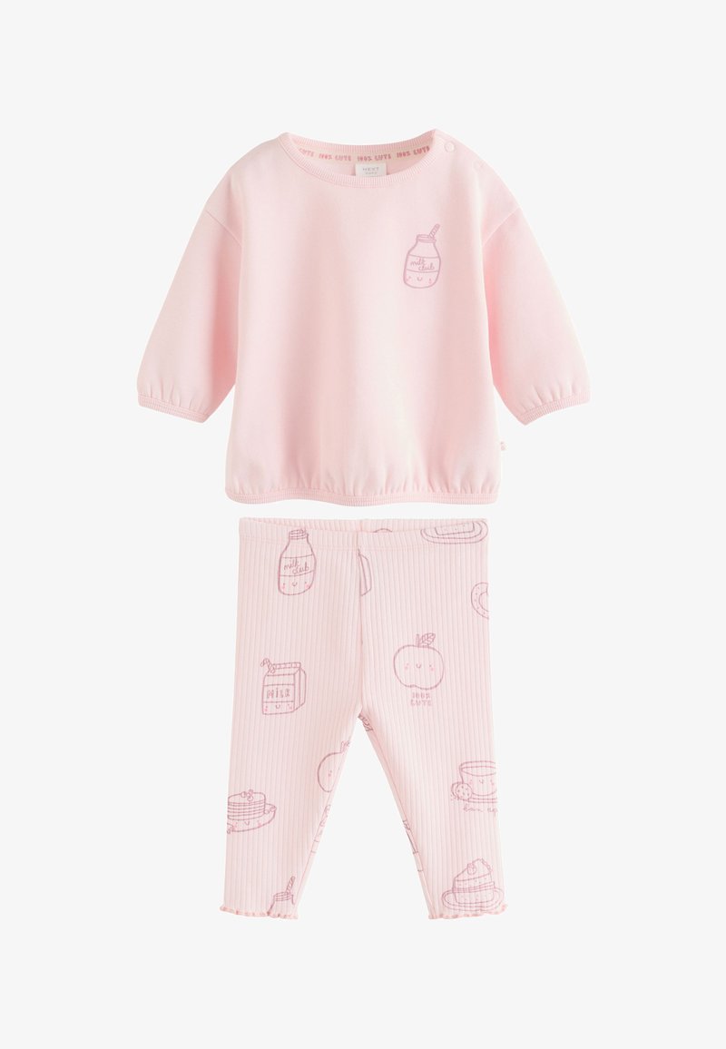 Haut à manches longues rose clair et leggings côtelés assortis avec des illustrations de bouteilles de lait souriantes, de fruits et de nourriture pour le petit-déjeuner.