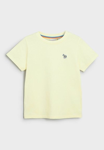 T-shirt in cotone giallo con collo tondo, maniche corte e un piccolo ricamo di zebra blu e nera sul lato sinistro del petto. Orlo piatto.
