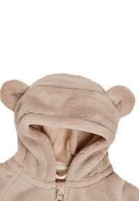 Light beige hooded jacket with soft fleece texture. Features round ears on the hood, front zipper closure, and interior lining in a muted tone.