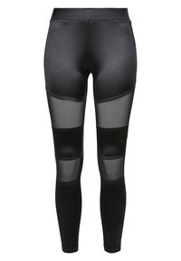 Zwarte leggings van een glad materiaal met doorschijnende meshpanelen op de dijen, die een contrast in textuur en ontwerp bieden.