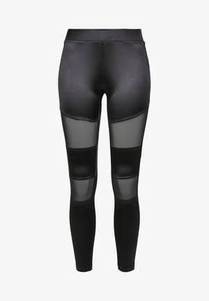 Schwarze Leggings aus einem glatten Material mit durchsichtigen Mesh-Einsätzen an den Oberschenkeln, die einen Kontrast in Textur und Design bieten.