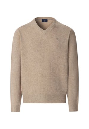 V-ringad tröja i ljus beige, tillverkad av mjukt stickat material. Har ribbade muddarna och fållen, med en subtil logotypdetalj på bröstet.