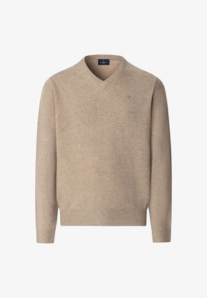 Licht beige V-hals trui, gemaakt van zacht gebreid materiaal. Heeft ribgebreide manchetten en onderrand, met een subtiele merkdetail op de borst.