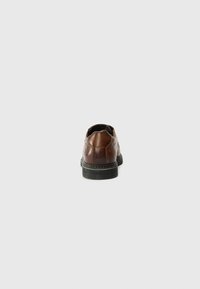 Brown leather shoe with a rounded back, textured surface, decorative stitching, and a rubber sole. The design is simple and functional.