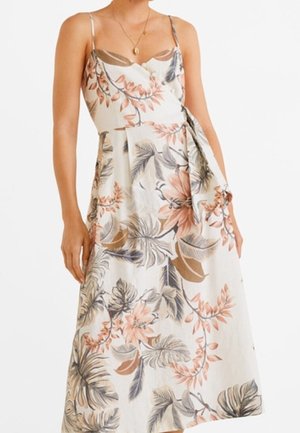 Florale maxi-jurk met dunne bandjes. Off-white achtergrond met perzik- en blauwe bloemenpatronen. Beschikt over een strikdetail bij de taille.