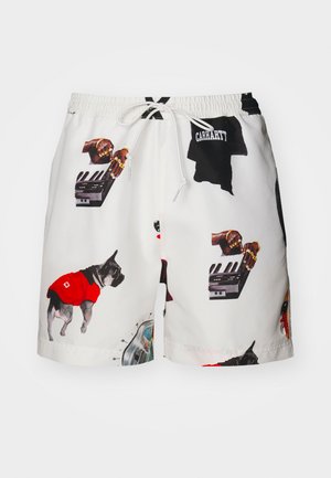 White swim shorts featuring colorful graphics of dogs, hands on a keyboard, and abstract designs. Drawstring waist and smooth fabric texture.