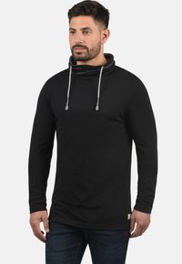 Sort langærmet tunika med cowl-neck og snor, lavet af blødt stof; har en slim fit og et lille logo mærke på kanten.