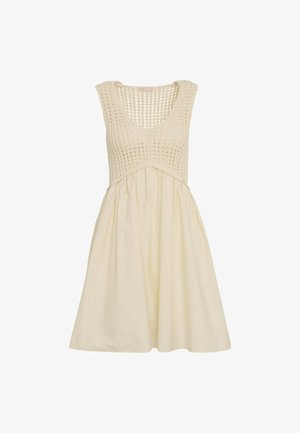 Abito senza maniche color crema con corpetto all'uncinetto e gonna fluida, con una parte superiore testurizzata e una parte inferiore in tessuto liscio.