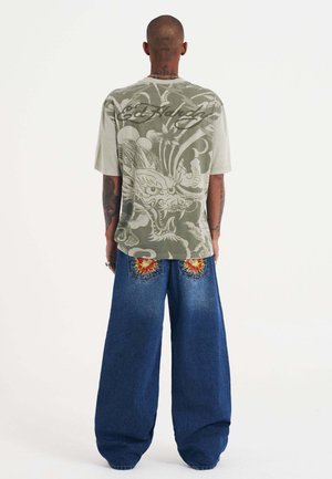 EXPLODING SKULL XXTRA - Flared Jeans - indigo