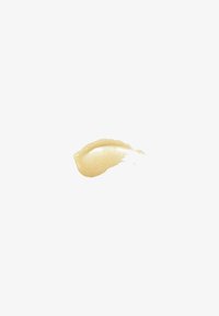 Crème beige clair étalée avec une texture lisse et brillante, affichant une finition légèrement réfléchissante sur un fond blanc.