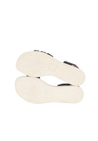 Svarta sandaler med en strukturerad vit gummisula. Tre justerbara remmar ovanpå. Slät svart övermaterial med kontrasterande bruna detaljer.