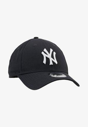 Black baseball cap made of cotton, featuring a white embroidered "NY" logo on the front, and a curved brim with a textured surface.