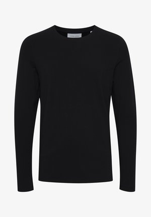 T-shirt noir à manches longues en tissu doux, avec un col rond et une silhouette ajustée, sans motifs ni ornements.