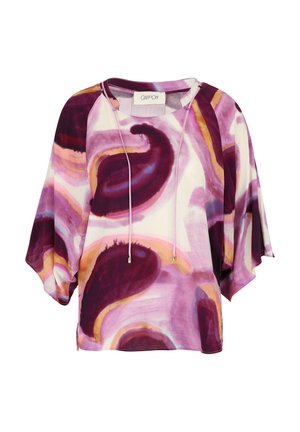 Luźna bluzka z lekkiego materiału, z wzorem w wirujące kształty w kolorach fioletowym, różowym i pomarańczowym. Zawiera sznurek w dekolcie.
