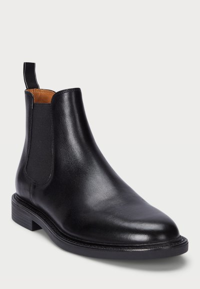 Black leather Chelsea boot with elastic side panels, rounded toe, smooth finish, and a short stacked heel. Features a pull tab for easy wear.