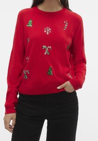 Rood gebreide trui met groene, geglitterde kerstbomen, witte sneeuwvlokken en kleurige suikerrietjes. Lange mouwen en ronde hals.
