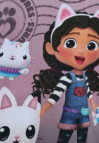 Charakter, der ein gestreiftes Shirt und Latzhose aus Denim mit einem Katzenpatch trägt, neben zwei Cartoon-Katzen auf einem lila Hintergrund.