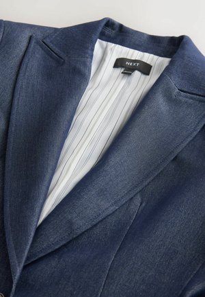 Navy blue blazer made of textured fabric. Features a notched collar and a striped interior lining with a tag labeled "NEXT."