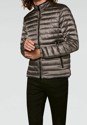 Padded gray jacket with a high collar, zip front, and side pockets. Features quilted design and smooth texture.