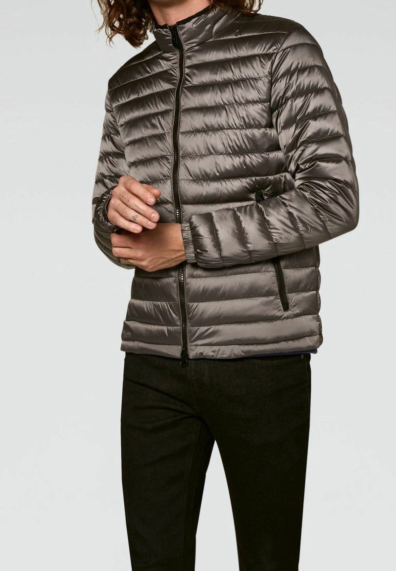 Padded gray jacket with a high collar, zip front, and side pockets. Features quilted design and smooth texture.