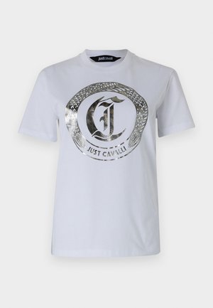 White cotton t-shirt featuring a metallic silver snake design encircling the "Just Cavalli" logo. Crew neck with short sleeves.