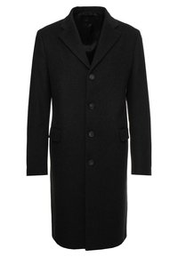 Cappotto di lana nera con rever a punta, chiusura con cinque bottoni e due tasche laterali; silhouette dritta con una morbida texture.