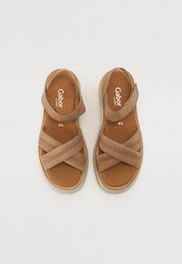 Brown suede sandals with cross-over straps, adjustable ankle strap, tan footbed, and light rubber sole. Brand name "Gabor" visible inside.