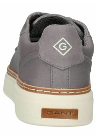 Gray canvas sneaker with white rubber sole. Features a leather accent on the heel and a stitched detail around the sole. GANT logo on the heel.
