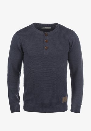 Navy knitted sweater with long sleeves, round neck, three brown buttons at the collar, and a ribbed hem. Features a branded leather patch.