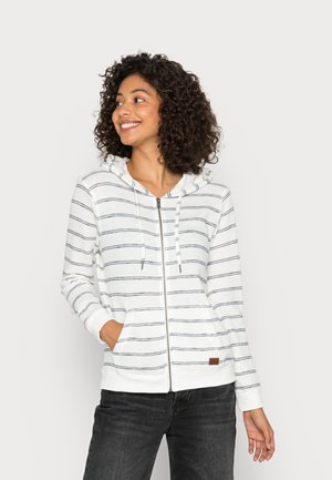 White zip-up hoodie with navy stripes, a drawstring hood, front pockets, and ribbed cuffs. Notable brown label on the hem.