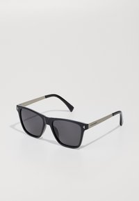 Black rectangular sunglasses with dark lenses and matte silver arms, Hawkers brand visible on the right temple.