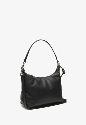 Sac à main en cuir noir avec une forme courbée, une bandoulière unique et des accessoires en métal argenté. Il présente une fermeture éclair sur le haut. Texture lisse.