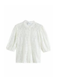 Balta mežģīņu blūze ar pūkainām piedurknēm, apa ļu kaklu un dekoratīviem ziedu rakstiem. Ir pogājams priekšpuse un teksturēts audums.