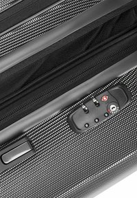 Black hard-shell suitcase with a textured finish, zippered compartments, and a TSA-approved locking mechanism. Features smooth edges and a sturdy handle.