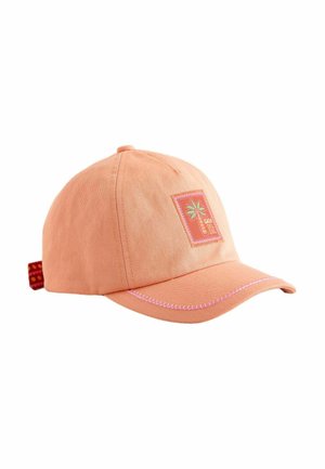 Peach-colored baseball cap with a stitched palm tree patch and "Casa del Sol" text, featuring pink stitching on the curved brim.