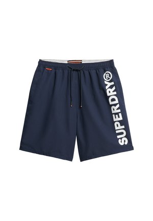 Navy swim shorts made of lightweight fabric, featuring an elastic waistband with drawstring and large white "SUPERDRY" logo along the side.