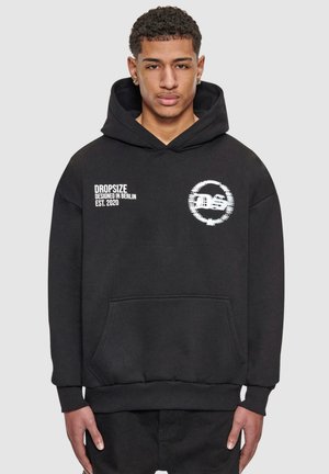Black hoodie made of soft fabric, featuring a front pocket, ribbed cuffs, and a graphic logo on the chest with text "DROPSIZE" and "EST. 2020."