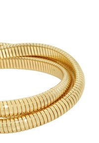 Gold-toned flexible bangle with a spiral design, featuring a series of evenly spaced, smooth metallic links. Glossy finish.
