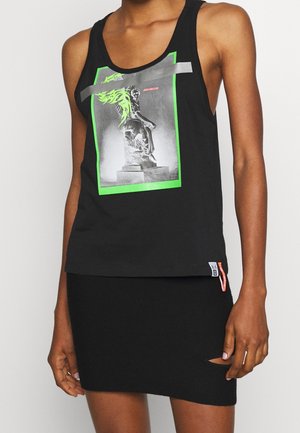 Débardeur noir en coton avec un imprimé graphique coloré comprenant des accents verts et un détail en ruban gris. Associé à une mini-jupe noire à côtes.