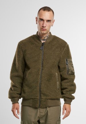 Zelená fleecová bomber bunda s texturovaným povrchem, zapínáním na zip vpředu, žebrovanými manžetami a kapsou na utility na levém rukávu.