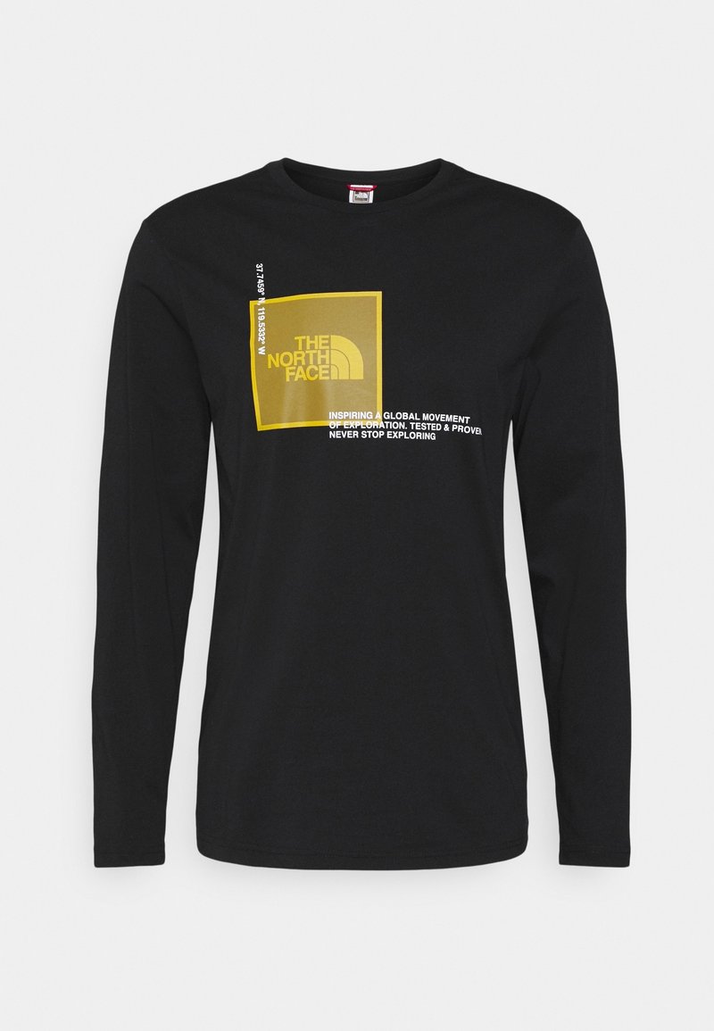 Black long-sleeve t-shirt with round neckline featuring a yellow rectangular graphic and white text. Smooth fabric, casual fit.