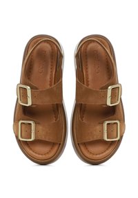 Brown suede sandals with two adjustable buckle straps, cushioned insole, and a lightweight white sole for comfort and support.