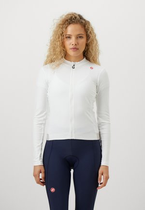 Weiße Radjacke mit langen Ärmeln, hohem Kragen und Reißverschluss vorne. Mit kleinem roten Logo auf der linken Brust. Glattes, dehnbares Material.